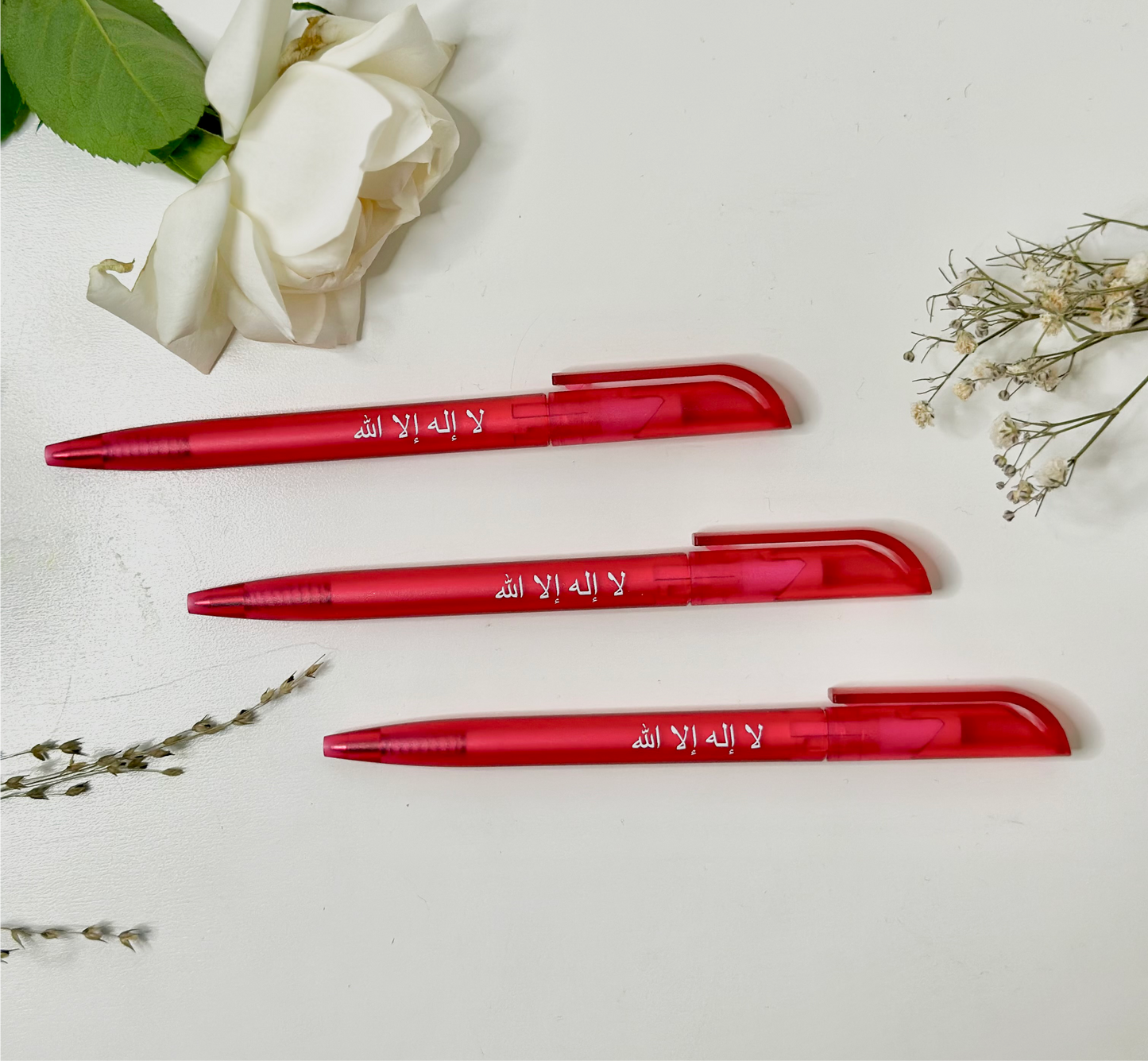 Ballpoint pen in Arabic “La ilahe illallah”, magenta